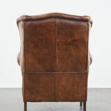Large sheep leather wingback chair correctly finished with decorative nails