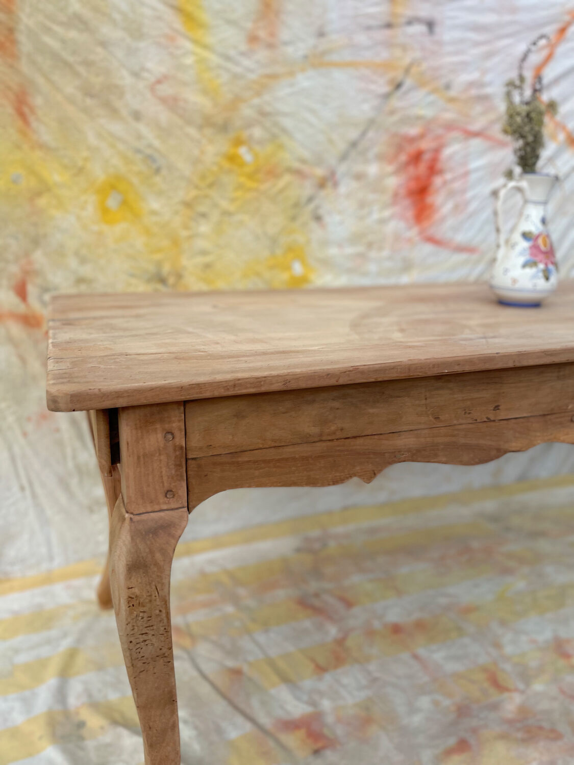 Curved farmhouse table in rustic wood, Provençal style.