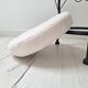 Black iron stool/pouf with its boucle fabric cushion.