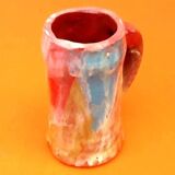 Traditional ceramic mug with a marbled glaze effect.