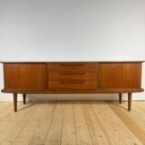Vintage teak sideboard with rounded edges and sliding doors – mid-century Scandinavian design.