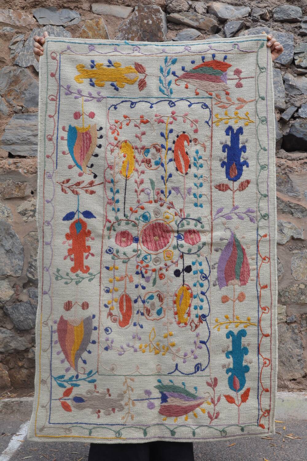 White suzani kilim rug with embroidered colorful patterns