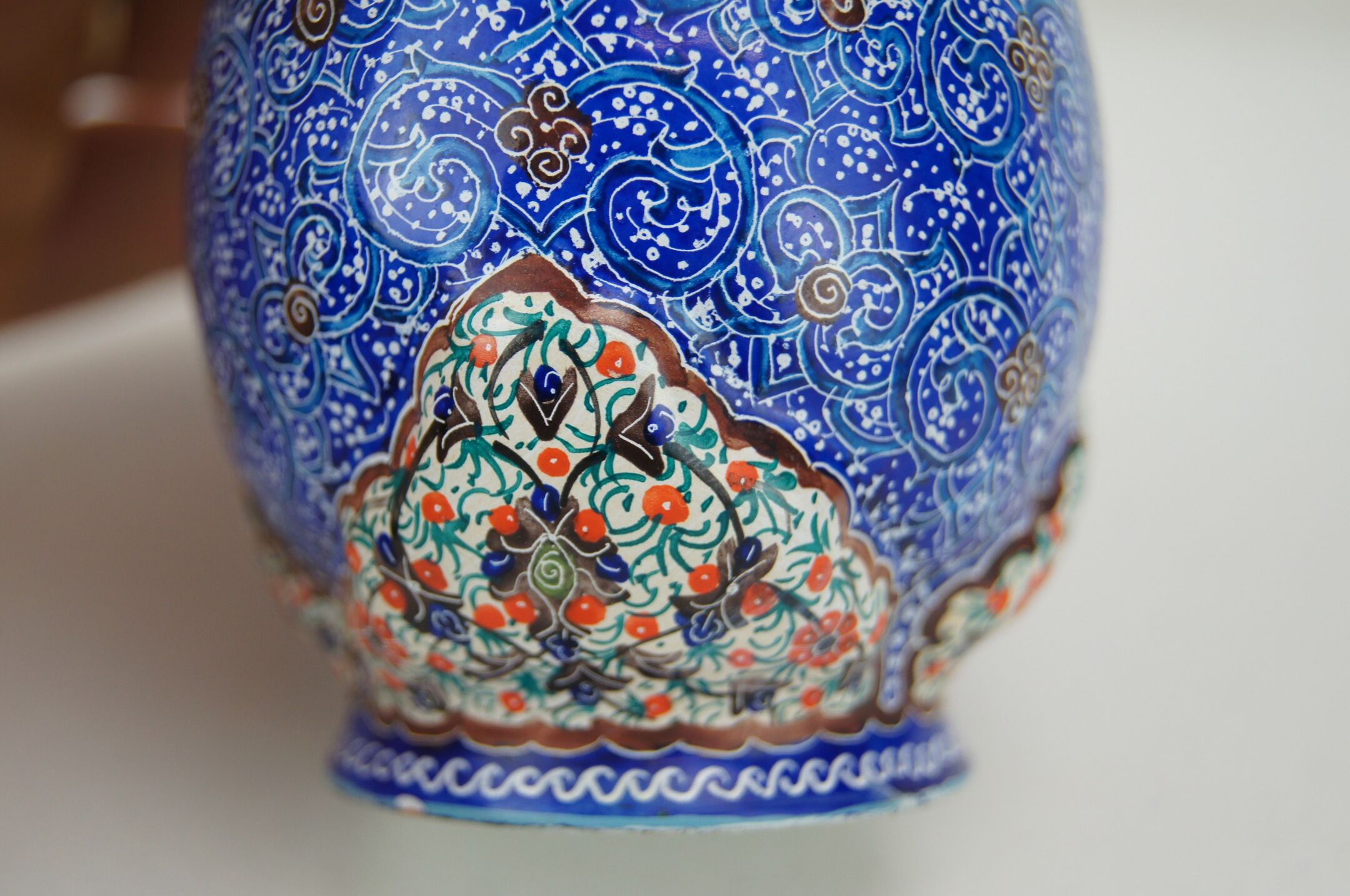 Piriform vase with a flared metal collar enamelled with a polychrome decoration, marked "Amini Iran" on the reverse.