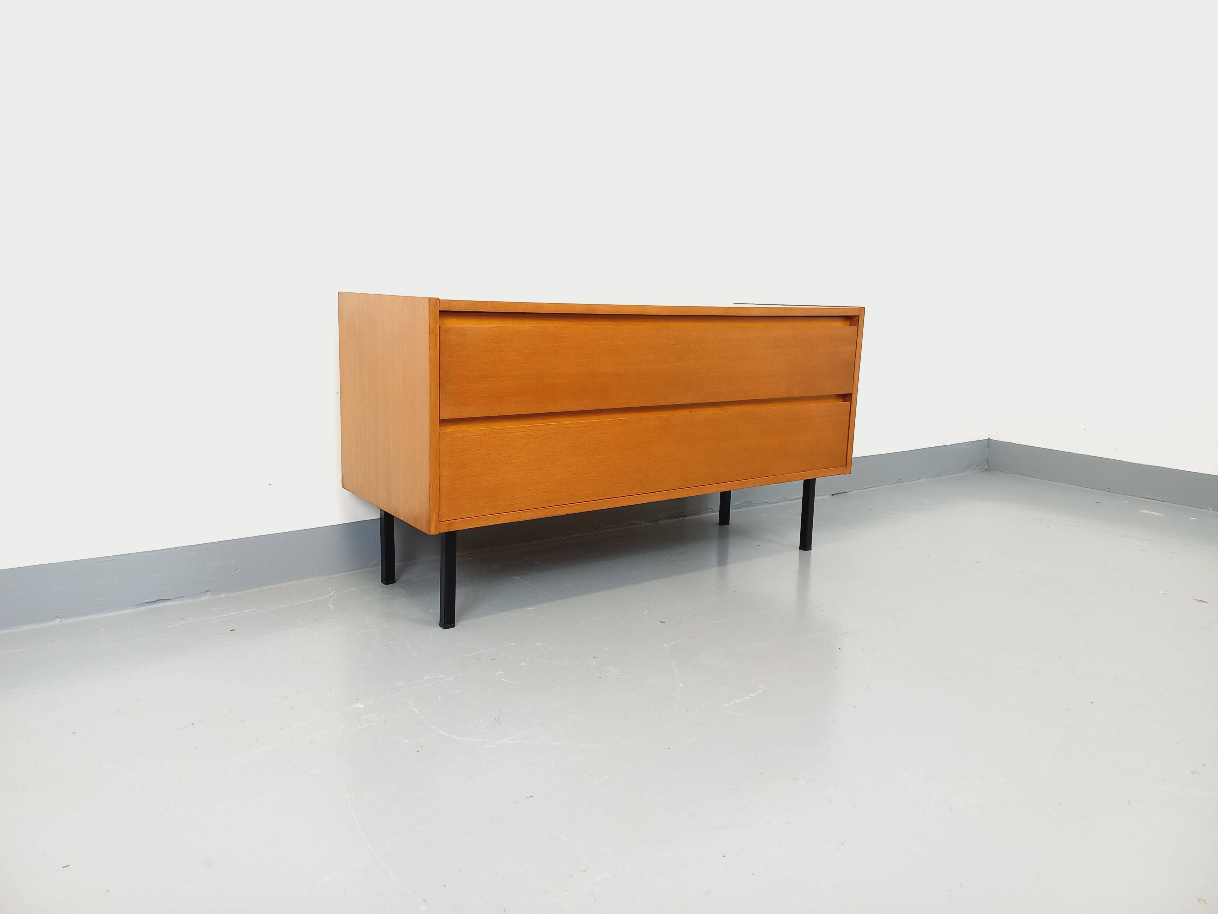 Small vintage Scandinavian sideboard in modernist style made of light oak wood.