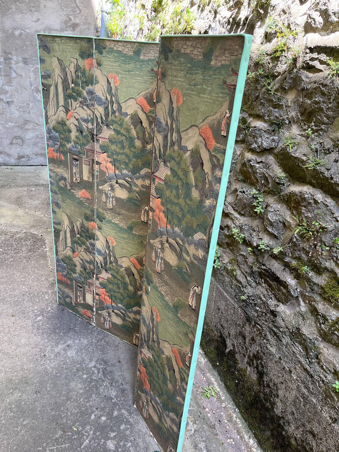 Wooden screen in Asian style, covered with Chinese wallpaper.