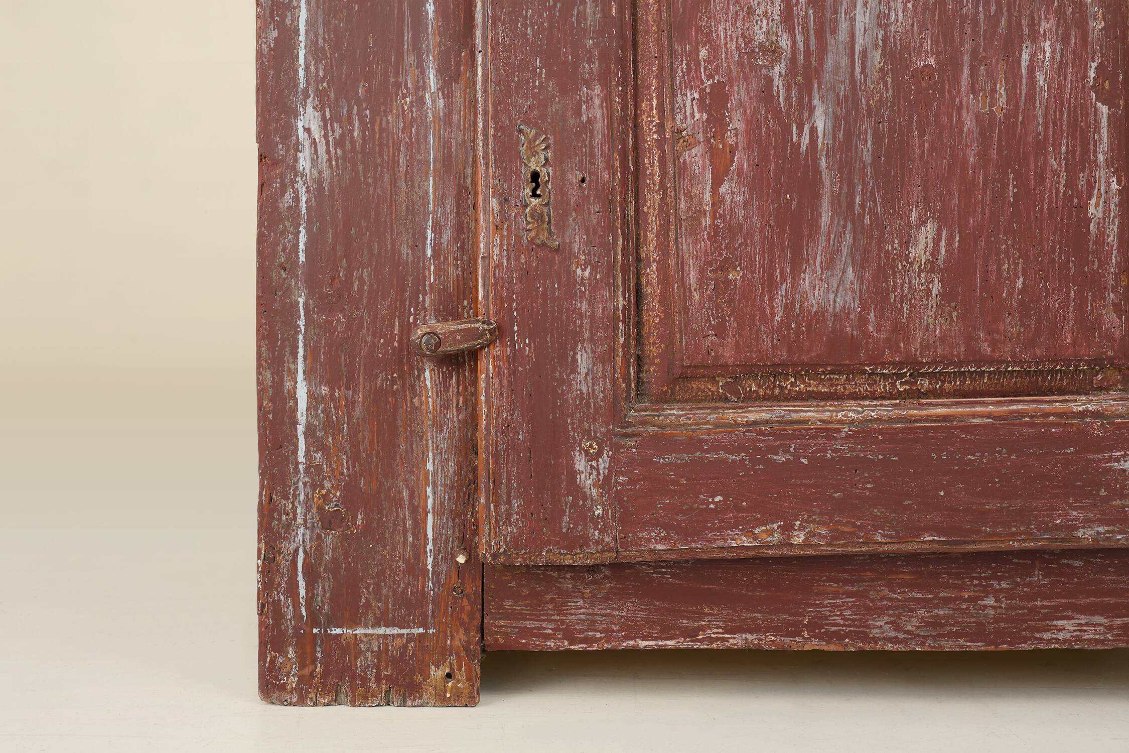Rustic Parisian cabinet in pine wood with old burgundy paint layers, ca. 18