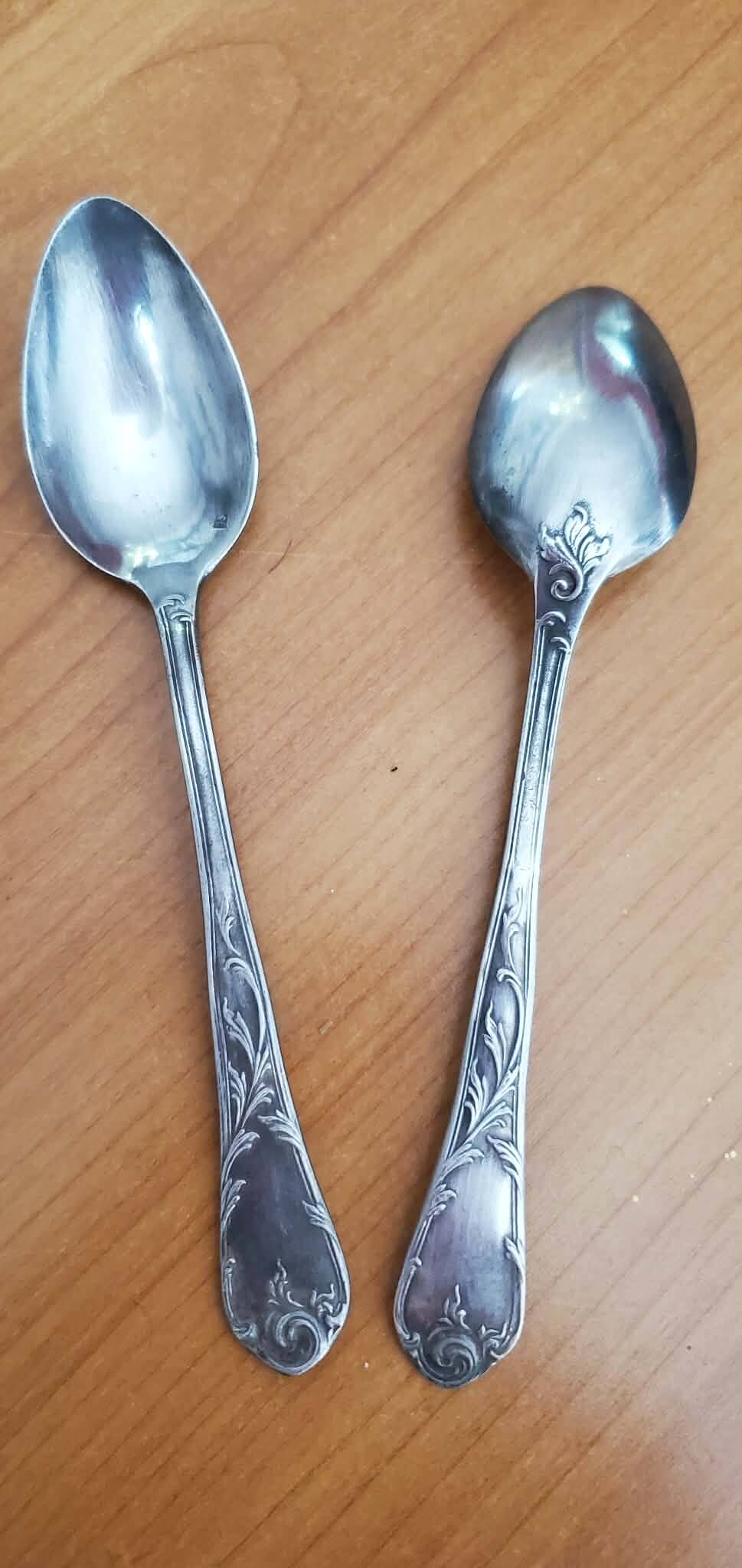 Many silver-plated metal teaspoons.