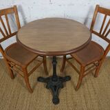 oak tray table with cast iron legs and pair of bistro chairs