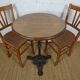 oak tray table with cast iron legs and pair of bistro chairs