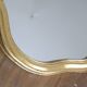 Golden mirror in wood and gold leaf