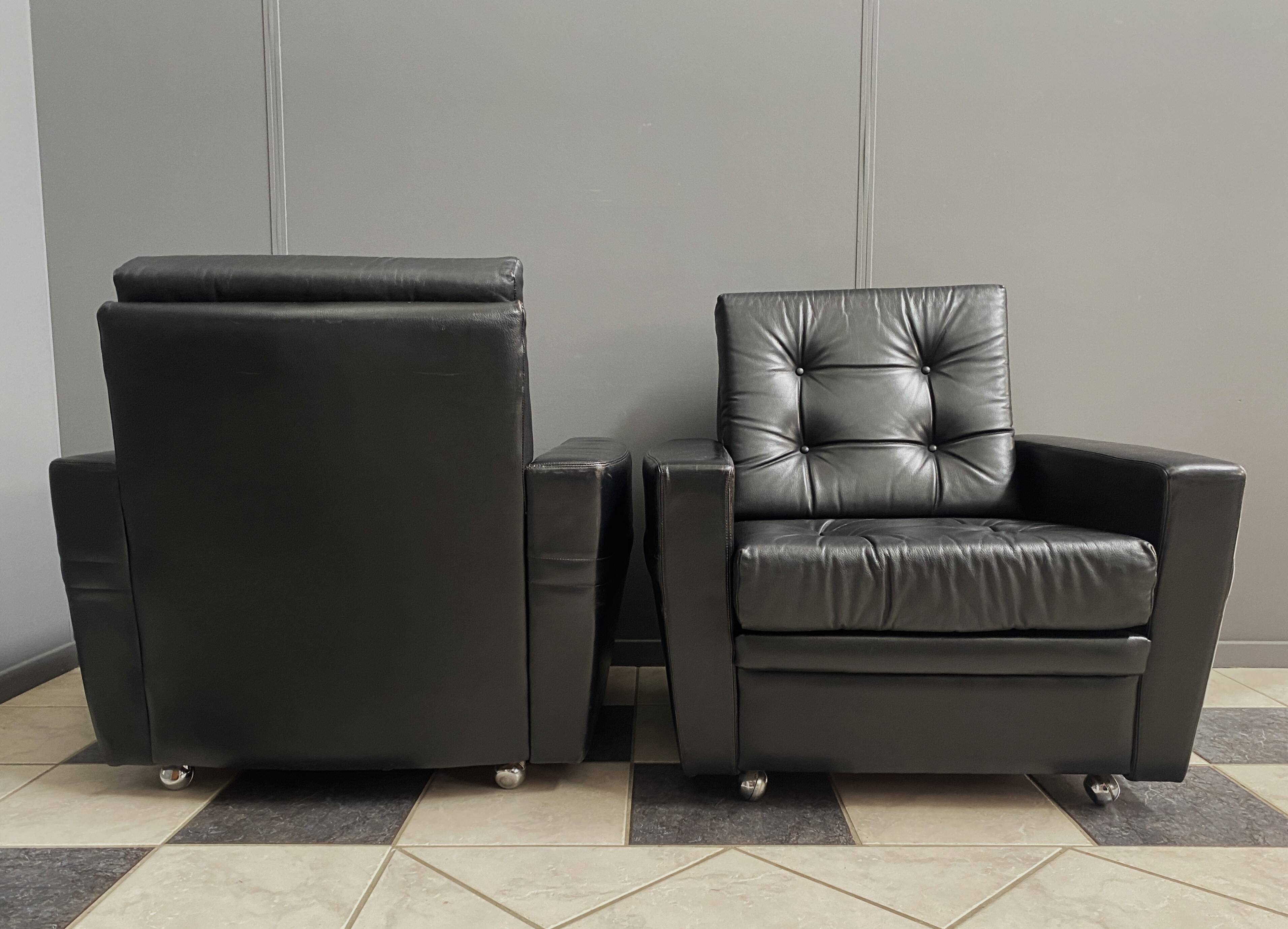 2 Black leather arm chairs 1960s on wheels