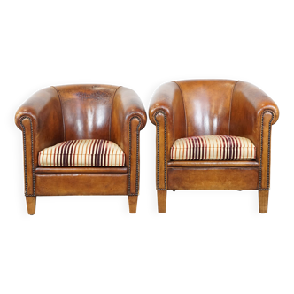 Set of 2 cognac-colored sheepskin club chairs with colorful fabric cushions