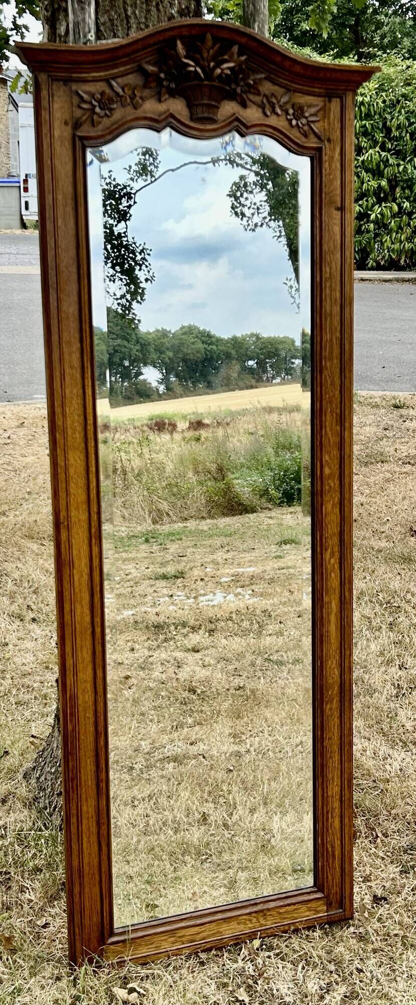 Large and old bevelled framed floor mirror.