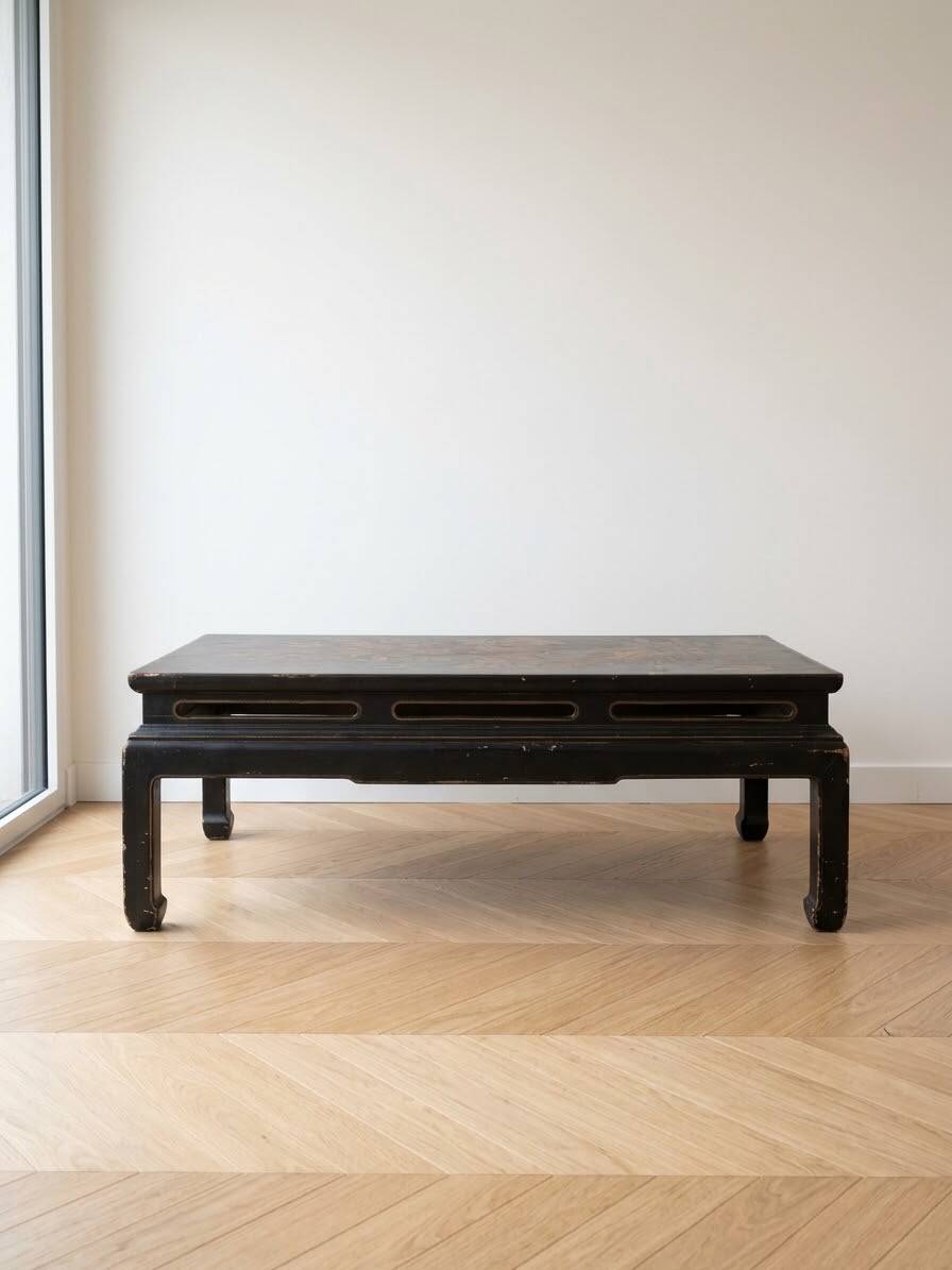 Antique Chinese coffee table in black and gold painted wood.
