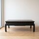 Antique Chinese coffee table in black and gold painted wood.
