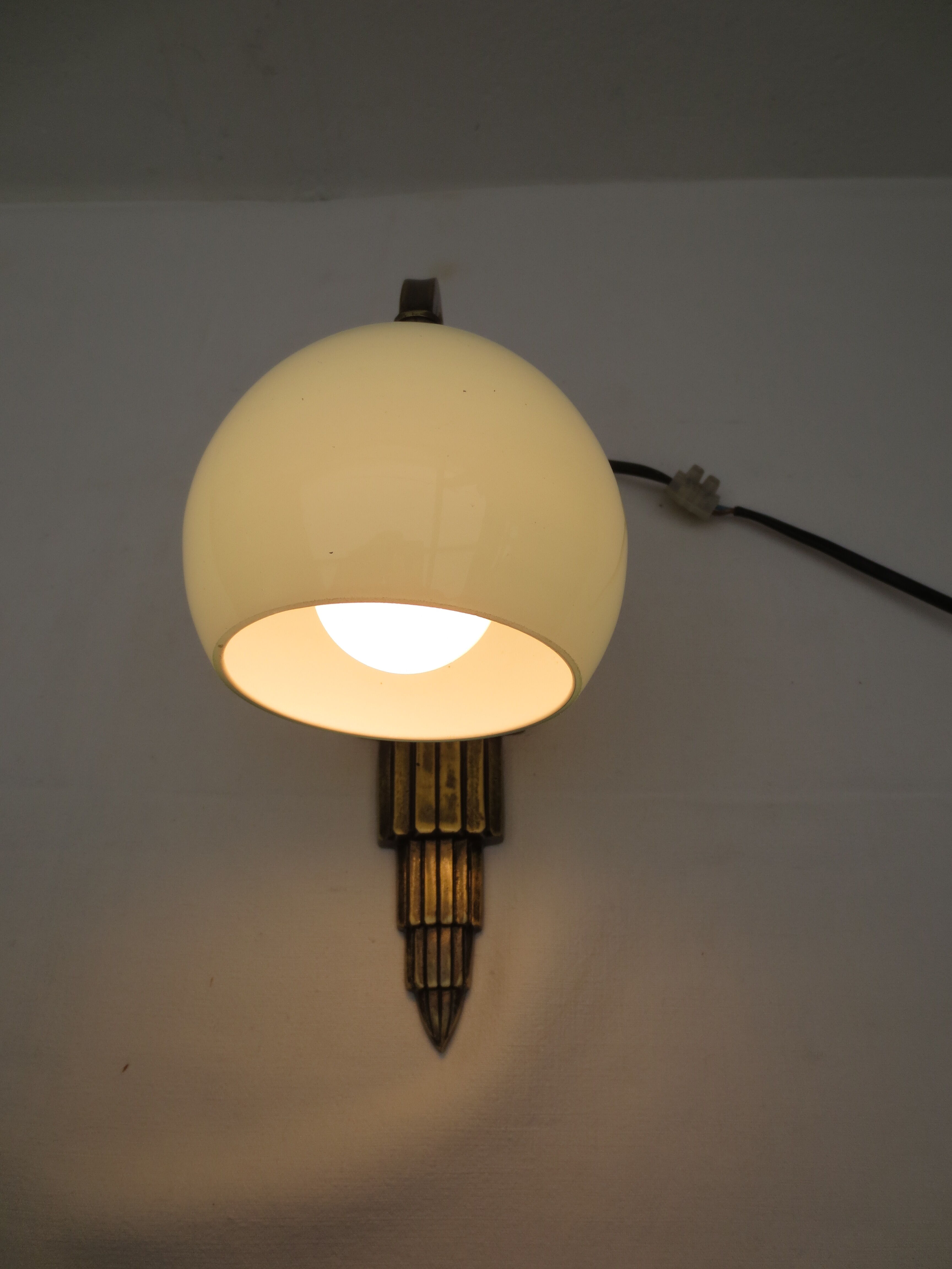 Art deco wall lamp in brass and soft blue opaline globe