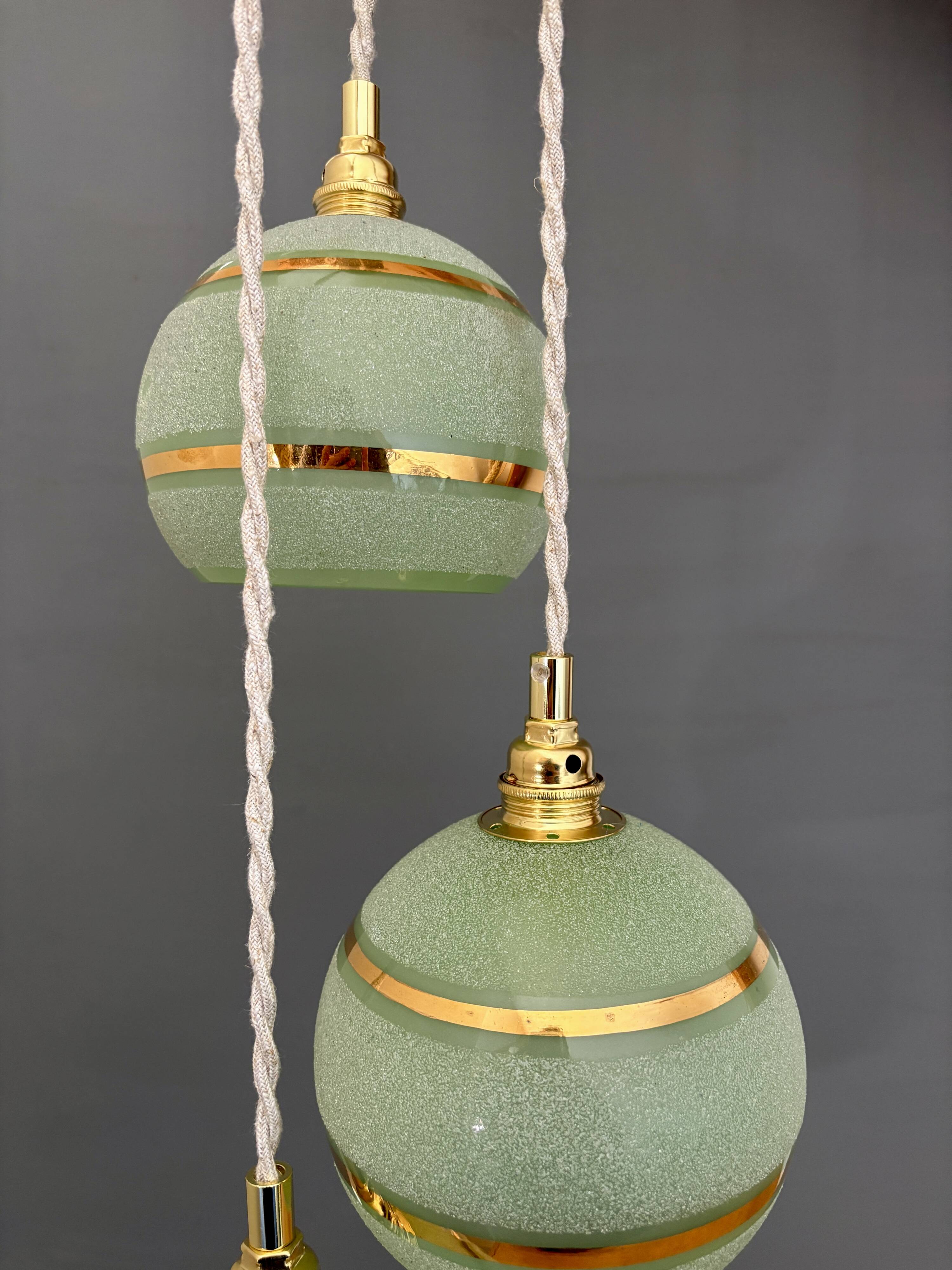 Suspension triple vintage glass globes in frosted green and gold.