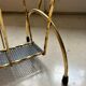 Vintage gold metal magazine rack from the 1960s.