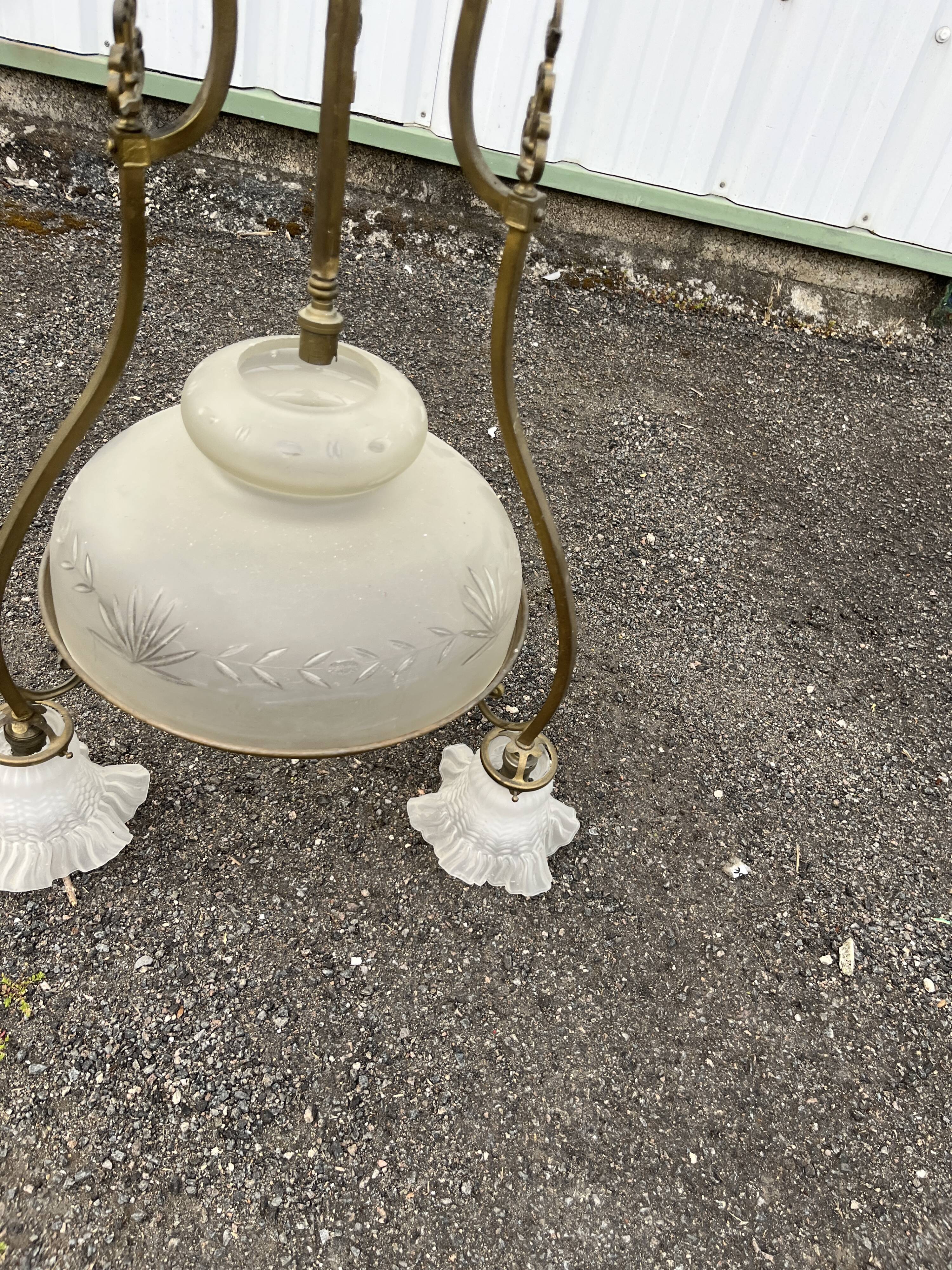 Antique brass chandelier with 3 lights and frosted glass shades.