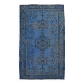 Vintage blue and black Turkish rug with traditional design, 163 × 268 cm