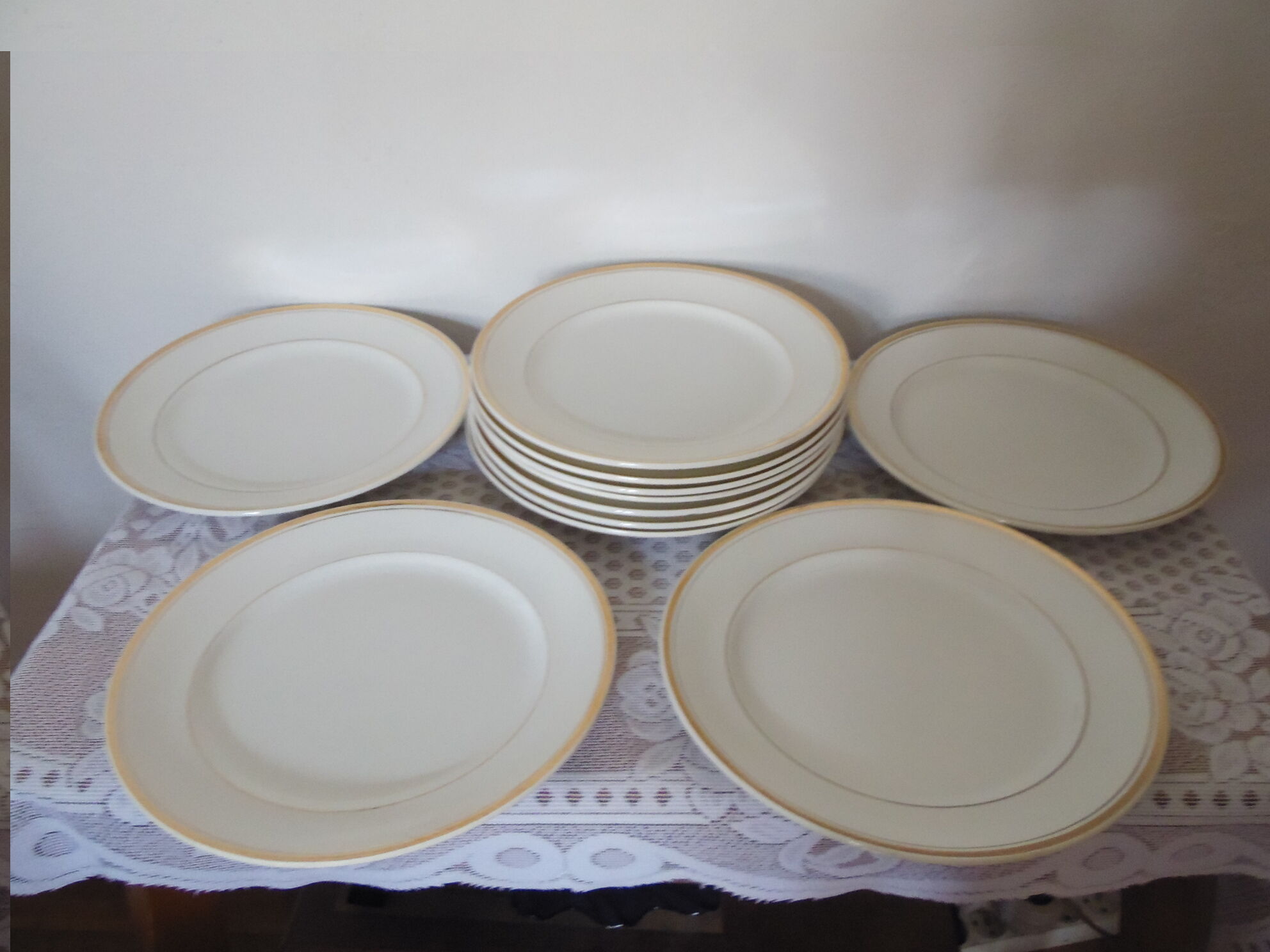Set of 11 flat white earthenware plates with gold edging