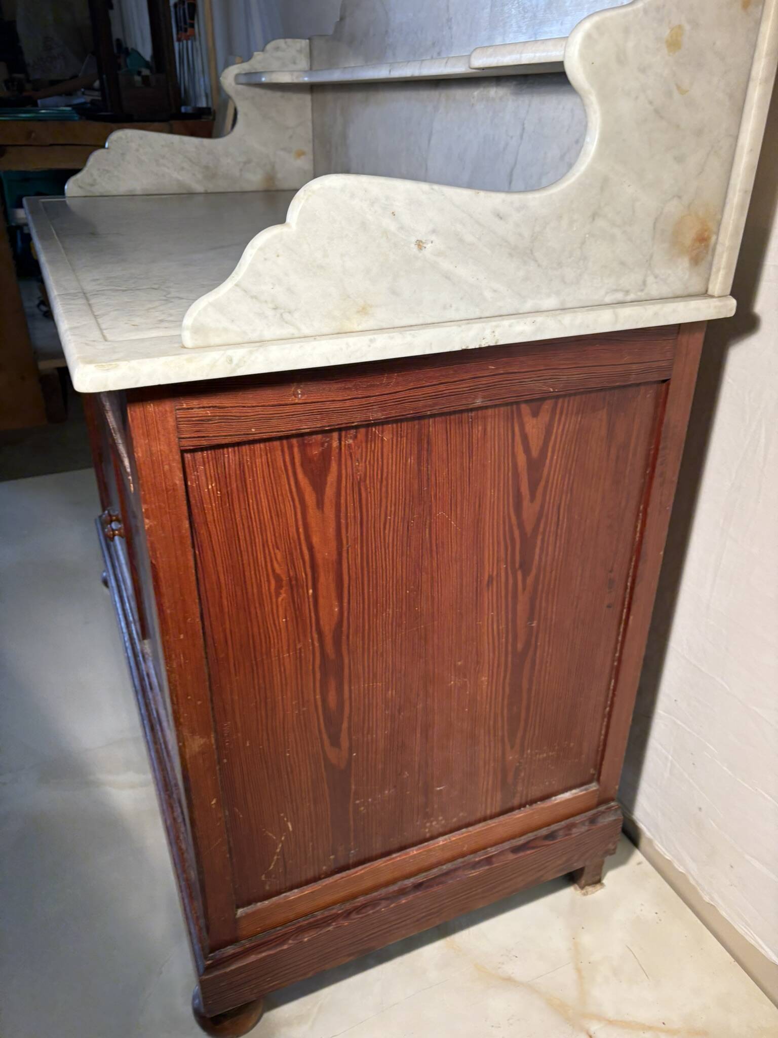 Antique wood and marble kitchen sideboard with carved backsplash