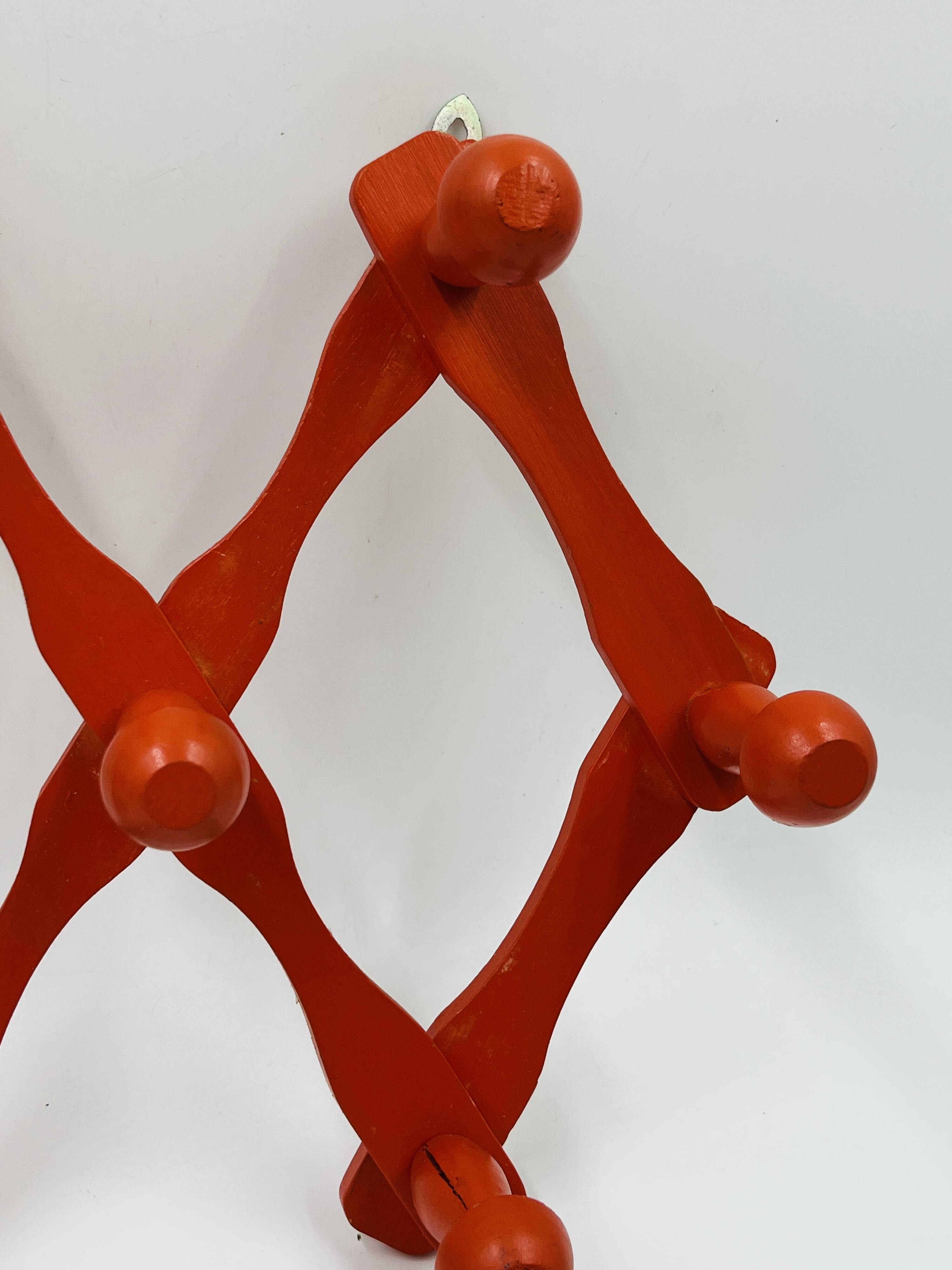 Vintage orange accordion coat rack