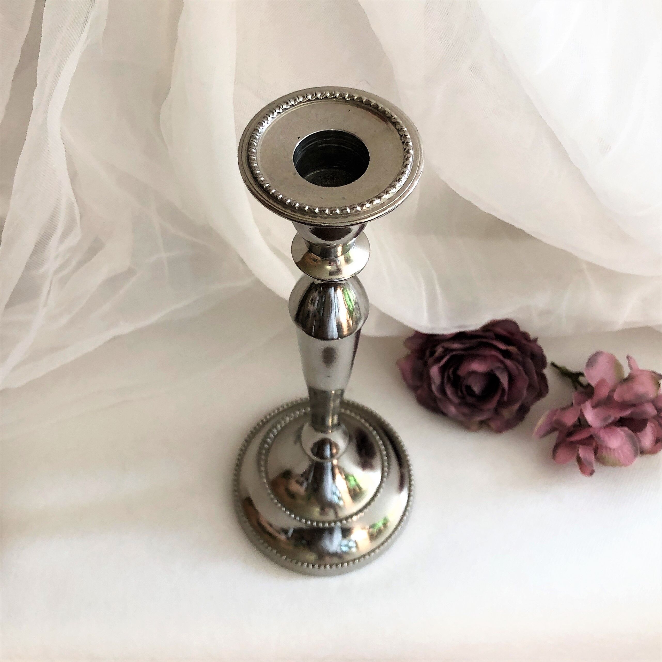 Chromed metal candle holder