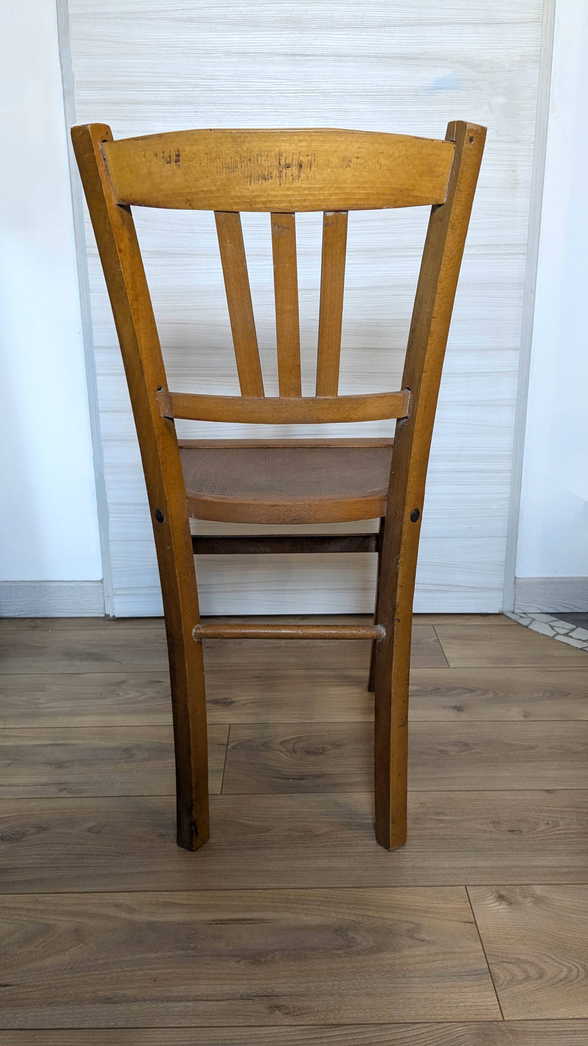 Antique patinated wooden bistro chair from the early 20th century.