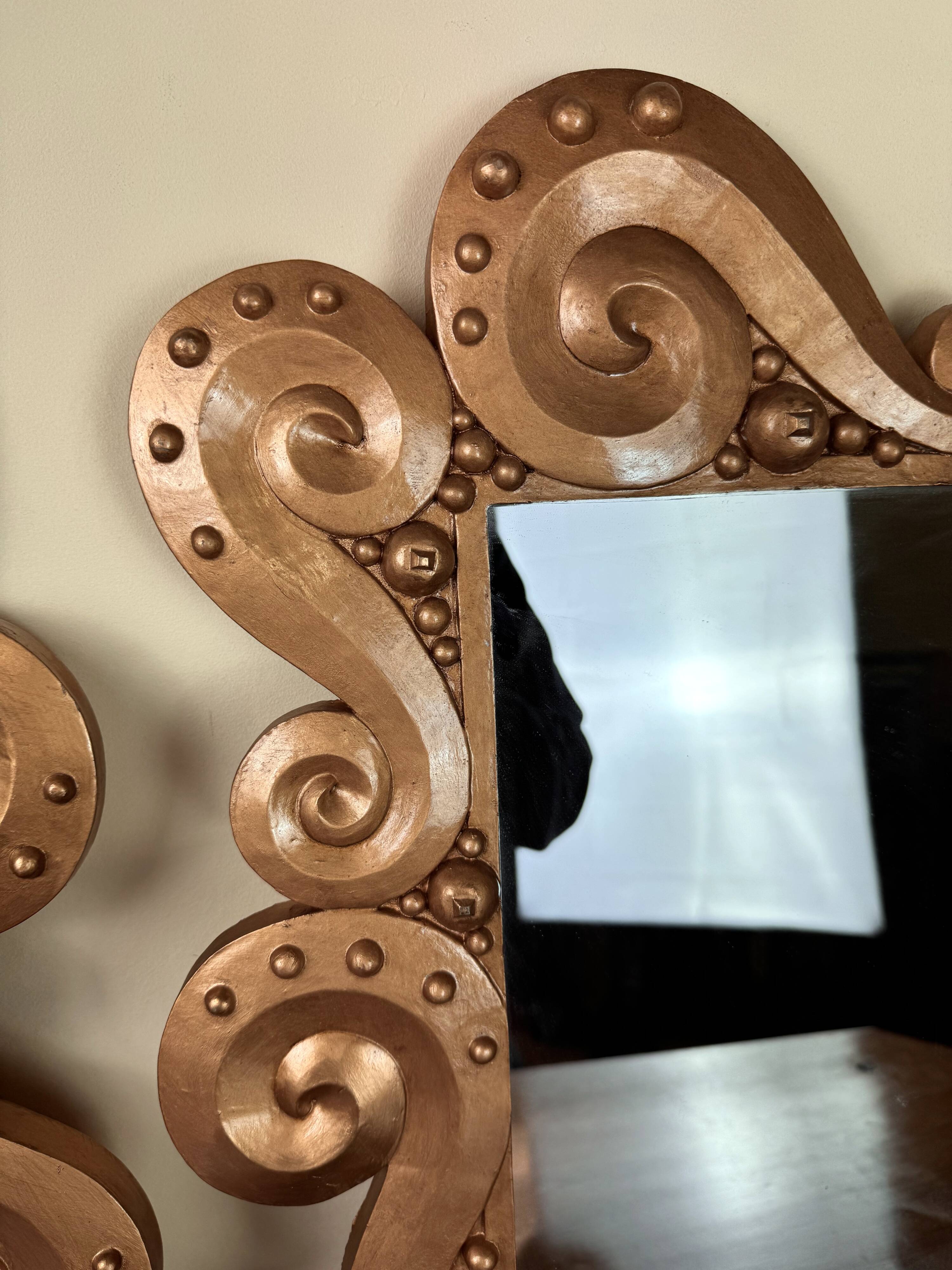 According to the model “the waves” by Jean Boggio: pair of designer gold mirrors circa 1980