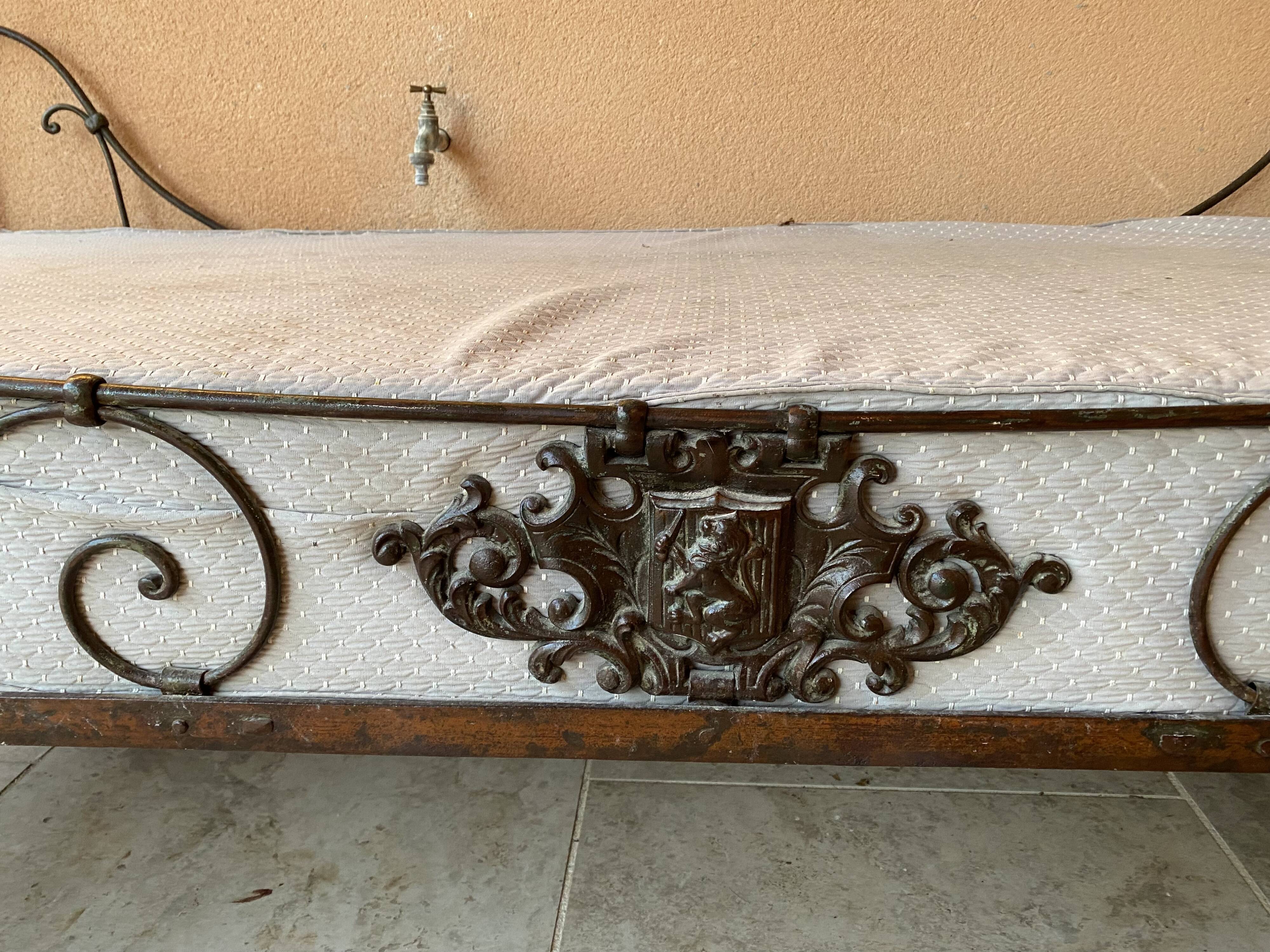 Wrought iron bed with mattress and decorative cover