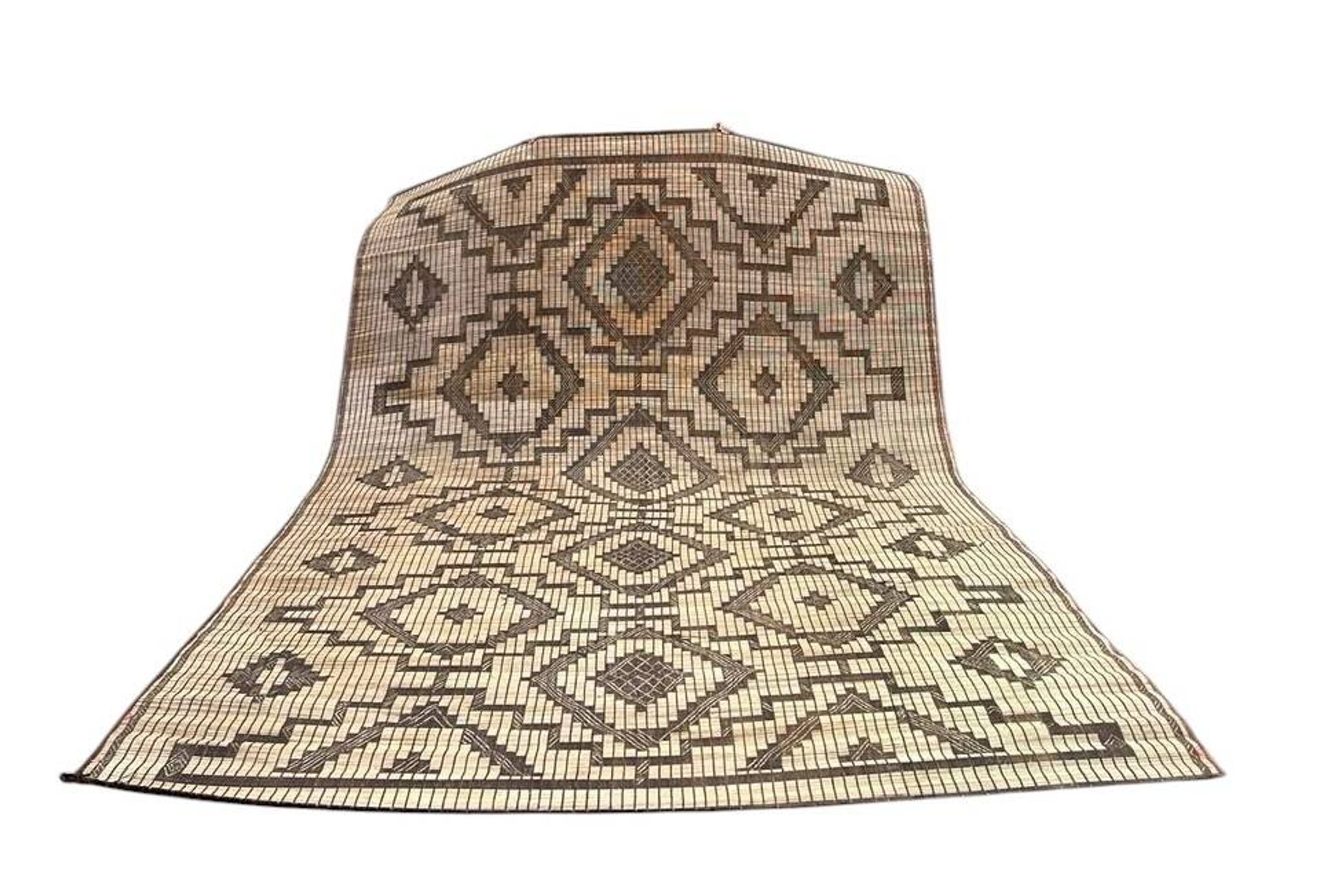 Vintage Touareg mat made of leather and reeds.