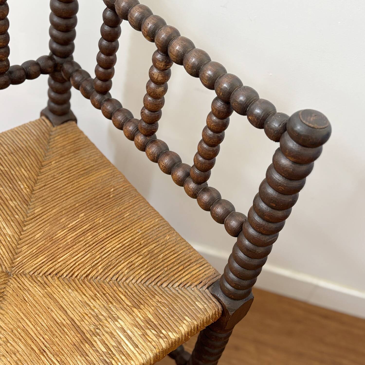 Turned wood corner chair with straw seat