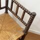 Turned wood corner chair with straw seat