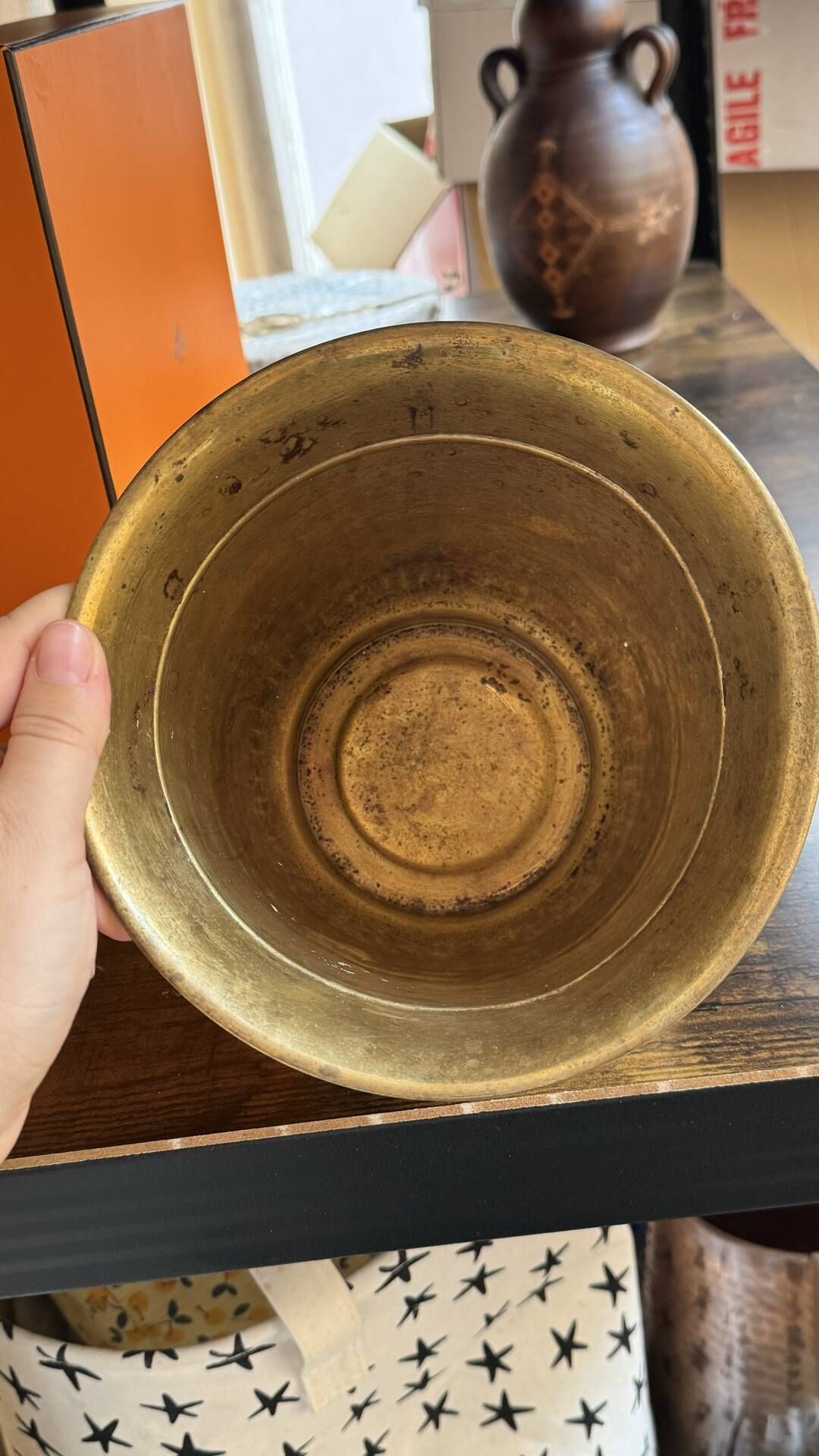 Pair of brass plant pots, decorated with cord and tassels.