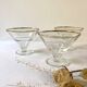 Trio of glass dessert bowls with gold rims, La Rochère, France