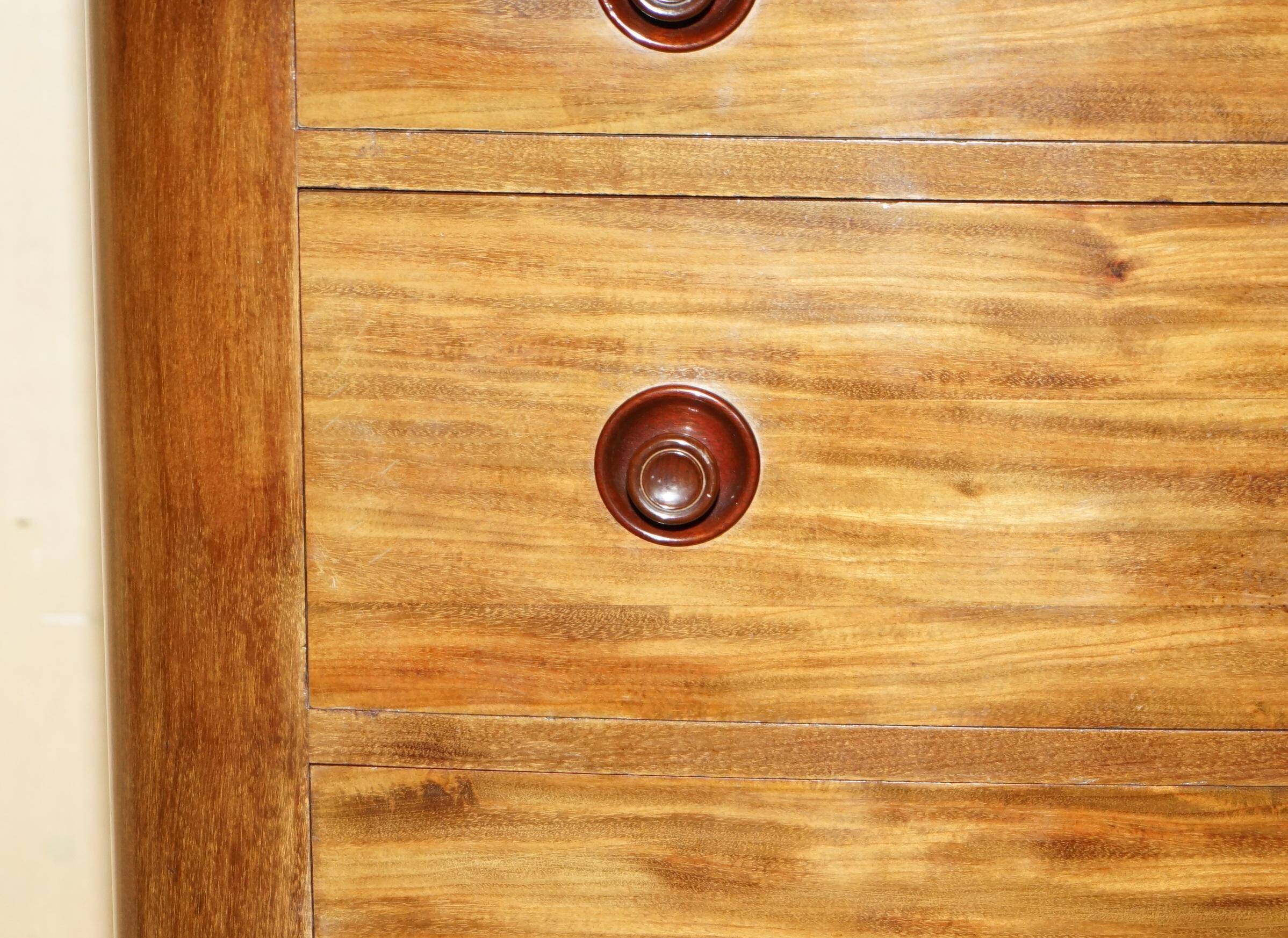 Pair of tall walnut chests of drawers with curved fronts in country style.