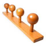 Vintage wall-mounted coat rack in solid pine.