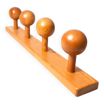 Vintage wall-mounted coat rack in solid pine.