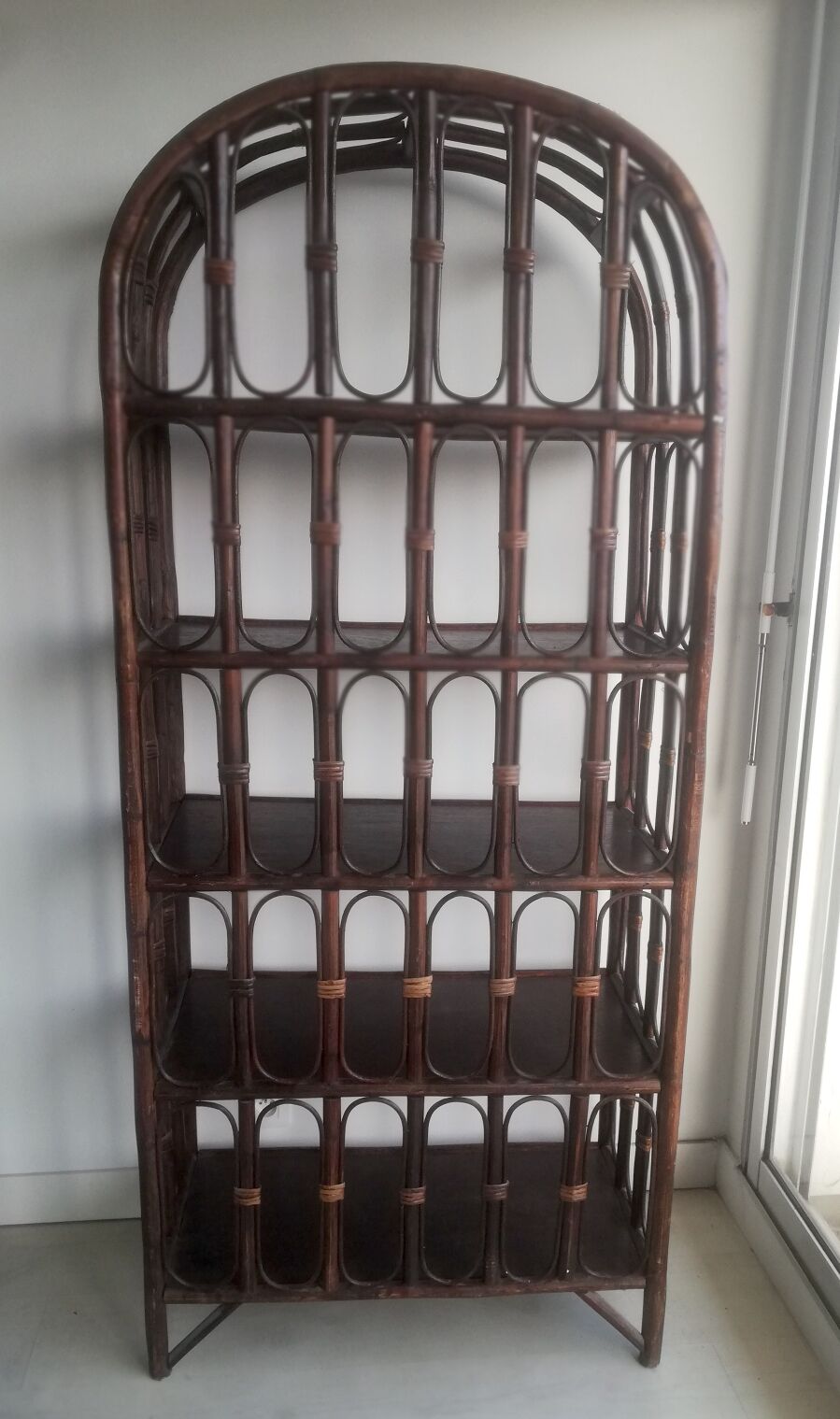 Library shelves in dark rattan