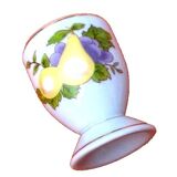 White porcelain egg cup decorated with pears / grapes.