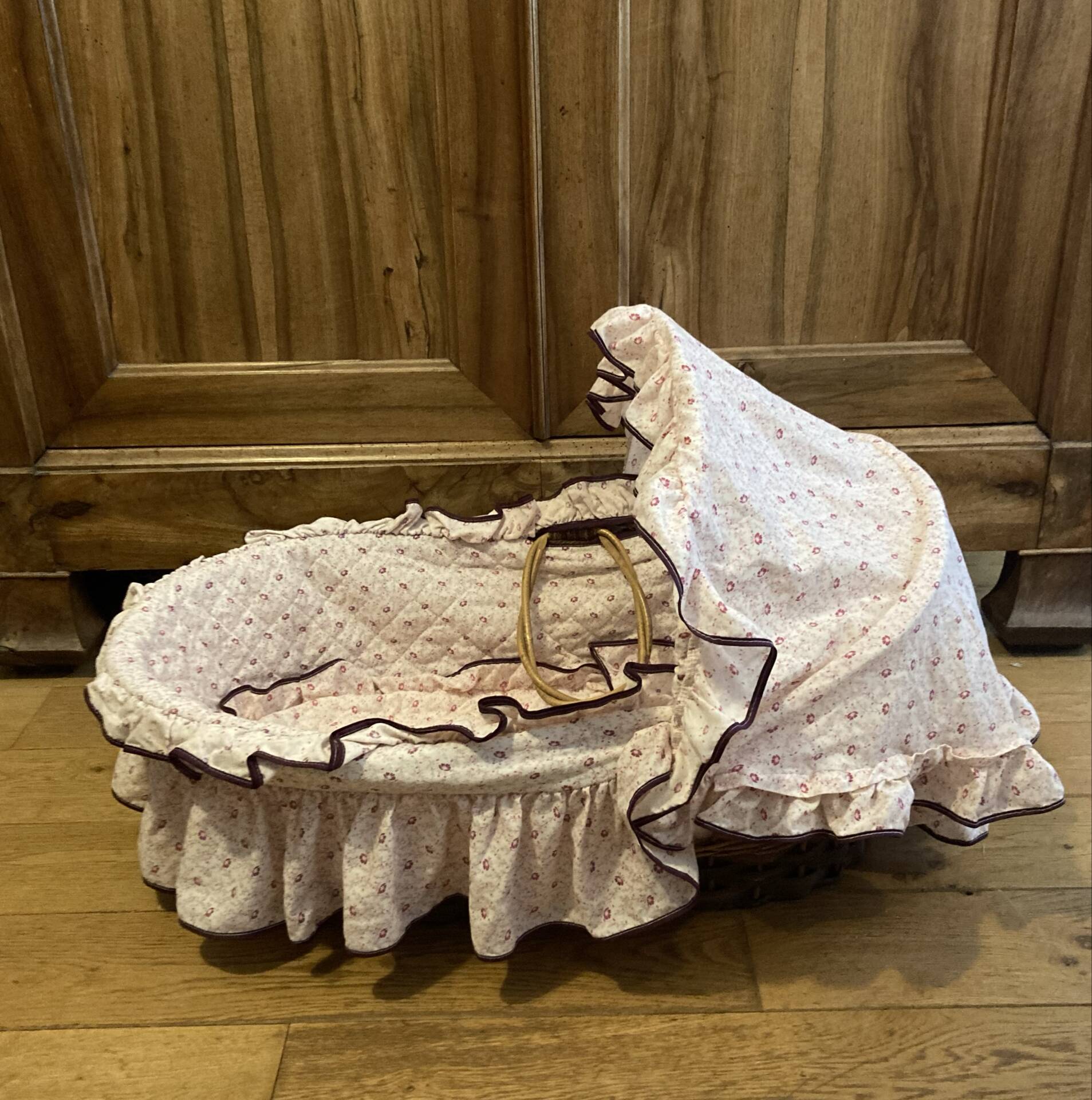 1960s wicker cradle with mattress and drapes.