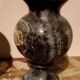 Pair of black serpentine marble vase-urns, early 20th century, Empire style