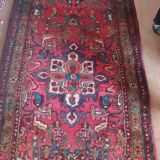 Vintage oriental rug from the 1930s. Handcrafted, handmade. Worn.