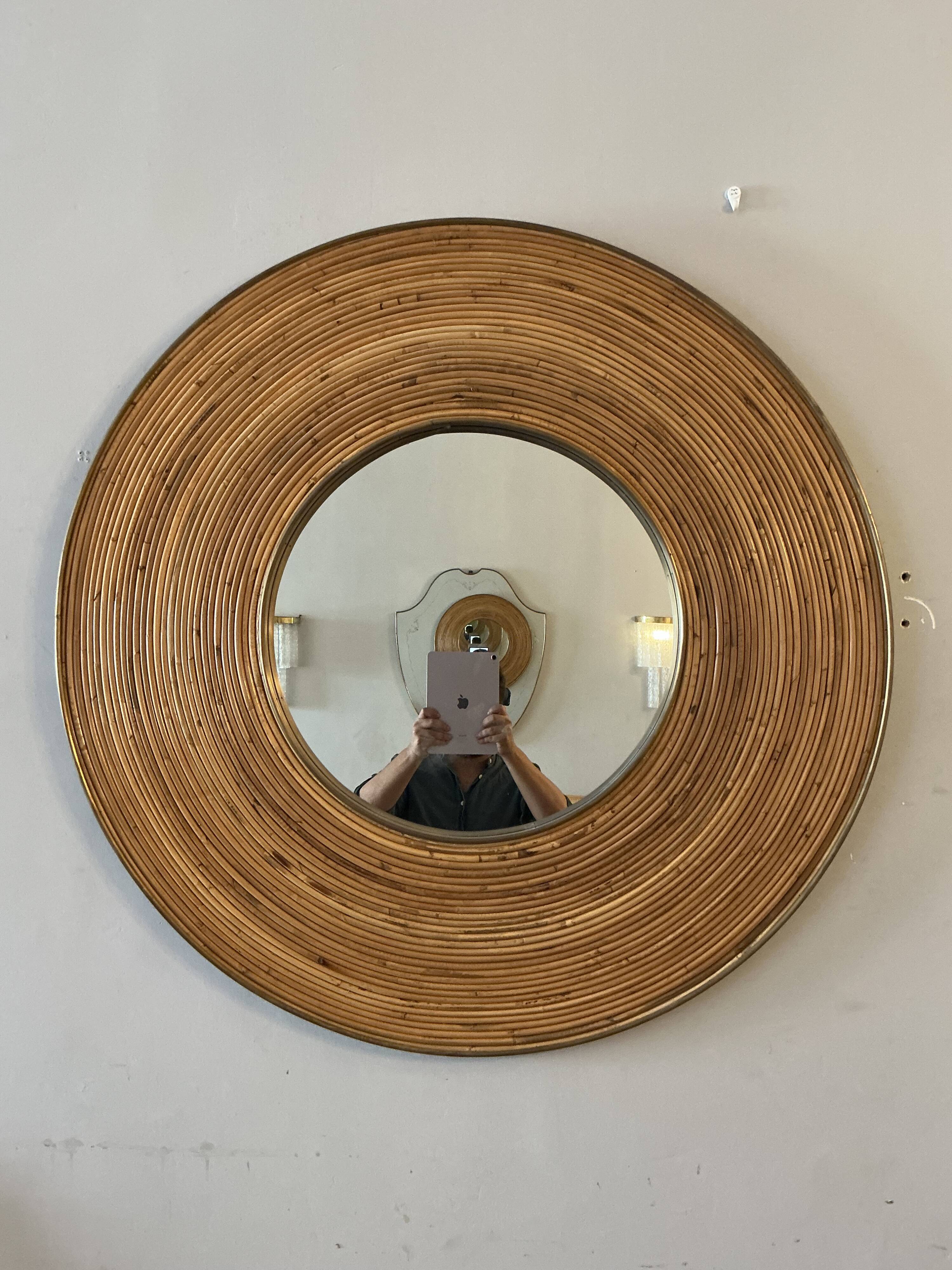 Large round mirror in rattan and brass