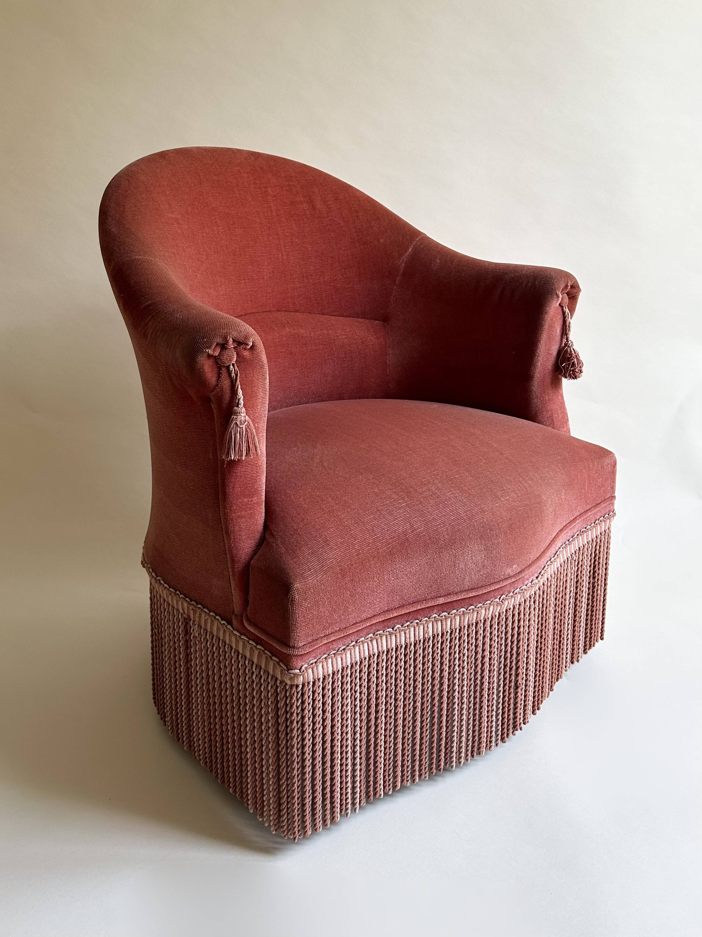 Pink-orange velvet tub chair