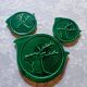 A trivet and two bottle holders in green Vallauris majolica.