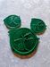 A trivet and two bottle holders in green Vallauris majolica.