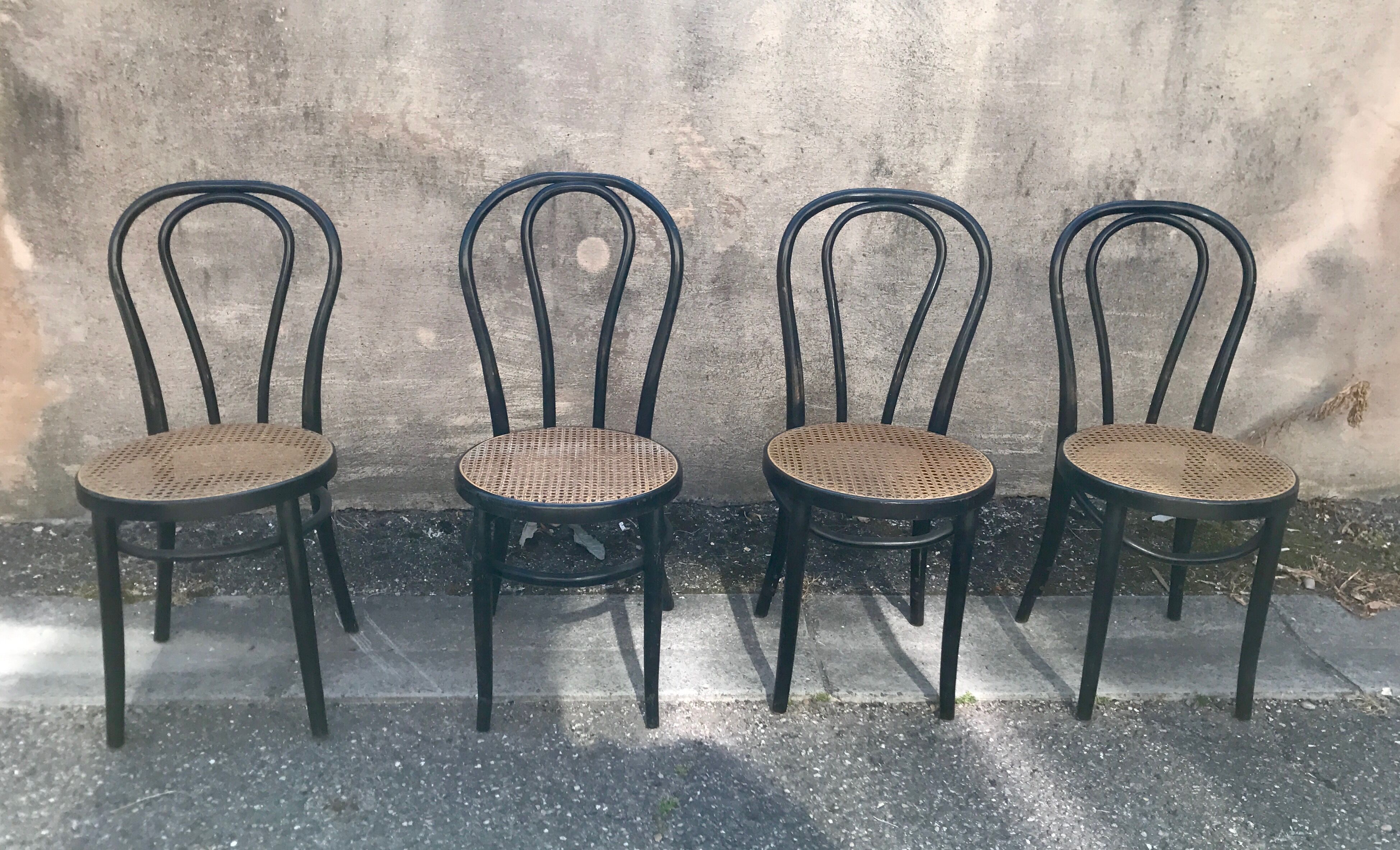 Two pairs of black 50s chairs - number 18 - cannée
