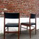Set of 2 vintage Scandinavian chairs in wood and black faux leather.